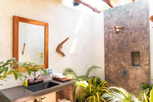 a bathroom with a sink and a shower at Ka´ana Surf in El Paredón Buena Vista