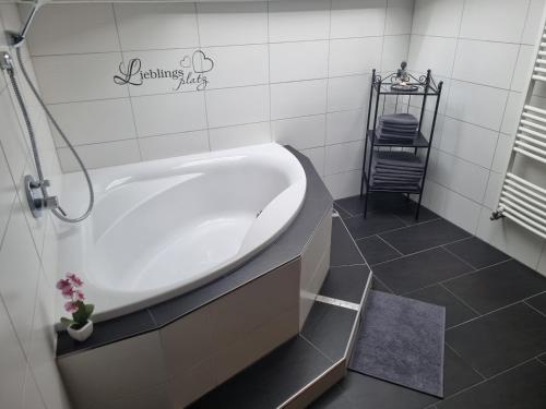 a white bath tub in a bathroom with a shower at Lieblingsplatzl in Neustift im Stubaital