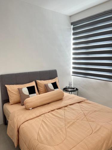 a bedroom with a large bed with a large window at Rayyan Condominium @ Metrocity Square in Kuching
