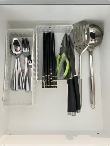 a drawer filled with utensils in a kitchen at Rayyan Condominium @ Metrocity Square in Kuching