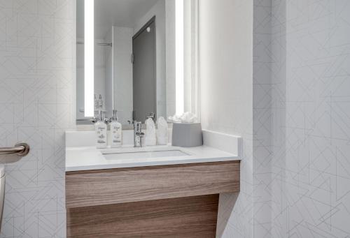 a bathroom with a white sink and a mirror at Holiday Inn Express Federal Way - Seattle South by IHG in Federal Way