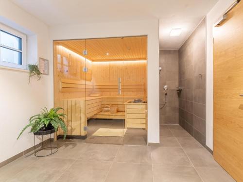 a bathroom with a shower stall and a toilet at Chalet Aquila in Niedernsill