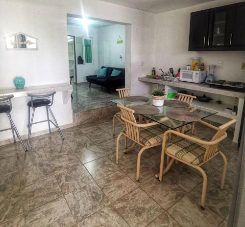 a kitchen and living room with a table and chairs at A pasos playa olas altas, Faro y Machado in Mazatlán