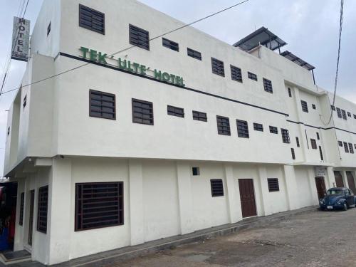 a white building with a sign on the side of it at Hotel Magnolia Tek Ulte´ in Comitán