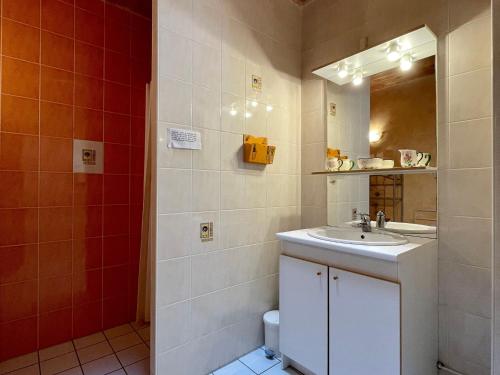 a bathroom with a sink and a mirror and a toilet at Gîte Saugues, 4 pièces, 6 personnes - FR-1-582-127 in Saugues