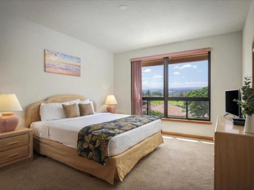 a bedroom with a bed and a large window at Shores at Waikoloa 301 - MCH in Waikoloa