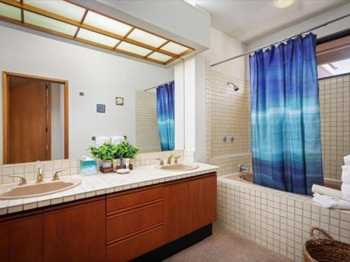 a bathroom with two sinks and a tub at Shores at Waikoloa 301 - MCH in Waikoloa