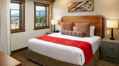 a bedroom with a large bed and two windows at Exquisite Upscale Oasis · Ski Resort in Breckenridge