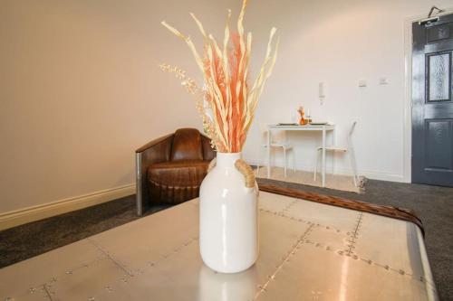 a white vase sitting on top of a table at Suite in the heart of Great Harwood in Great Harwood