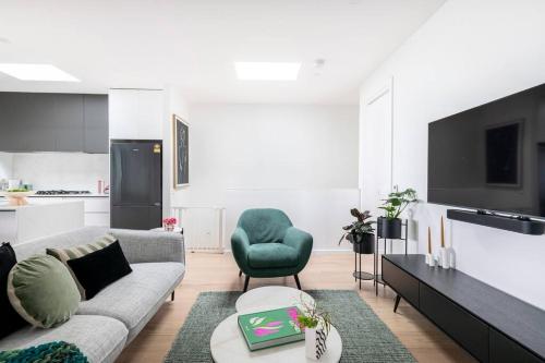 a living room with a couch and a tv at 3 BedroomTownhouse-free parking in Melbourne