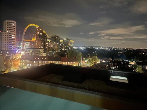 a view of a city skyline at night at Wembley Stadium Luxurious Apartment in London