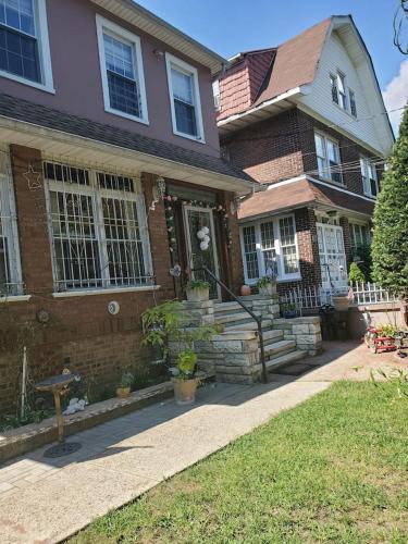 a brown brick house with a sidewalk in front of it at Lovely 2 bedroom Apartment with 2 Entrance and Parking in University Heights