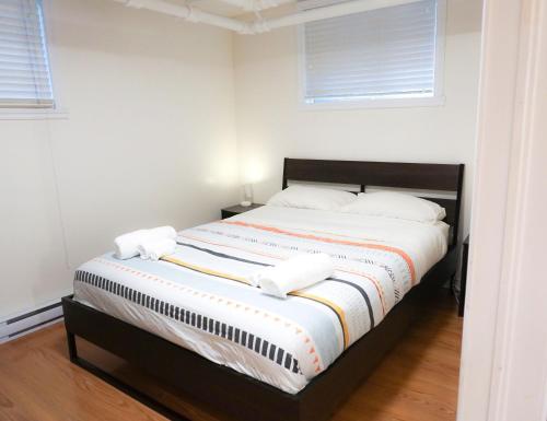 a white bedroom with a large bed with white pillows at Free Parking - Great 1BR near Henri Bourassa Metro in Montréal