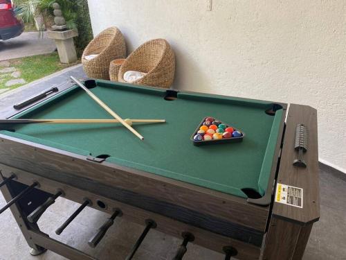 a pool table with cue balls in a bowl on it at Casa Brisa en Burgos Cuernavaca in Temixco