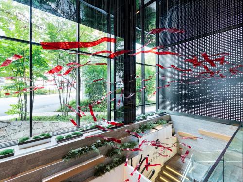 a group of redbons flying in a building at Millennium Mitsui Garden Hotel Tokyo - Ginza in Tokyo