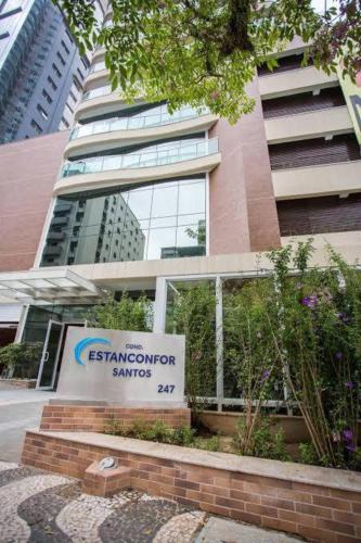 a sign in front of a building with a sign at Estanconfor Vista Mar em Santos in Santos