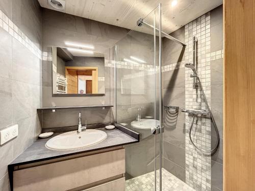 a bathroom with two sinks and a glass shower at Appartement Combloux, 2 pièces, 5 personnes - FR-1-560-61 in Combloux