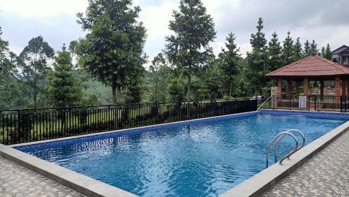 a large swimming pool with a black fence at Camp Bukit Biru Kalimantan 