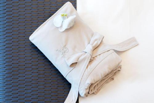 a towel with a flower on top of a wall at The St. Regis Changsha in Changsha