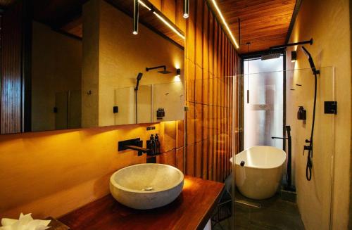 a bathroom with a large bowl sink and a mirror at El Recinto Luxury Hotel in San Miguel de Allende