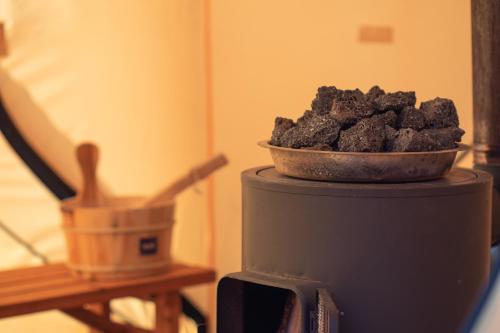 a bowl of coal sitting on top of a stove at 【飛騨高山】kiyomi荘-sou- 贅沢なプライベート空間 in Takayama