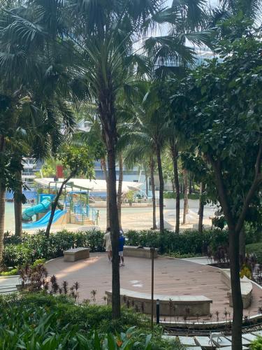 een park met palmbomen en een speeltuin bij Azure Urban Suite Room in Manilla