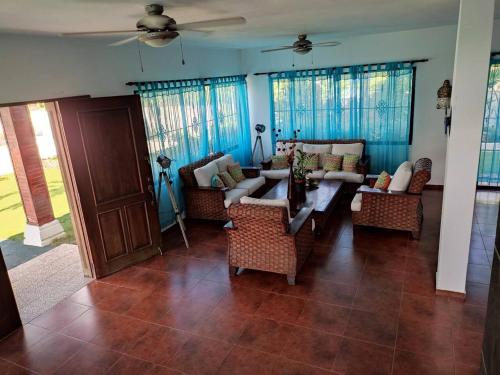 a living room with couches and chairs in a house at Villa piscina natural in Río San Juan