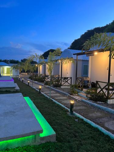 a resort with green lights on the grass at Camp Palo Bandera in Calatagan