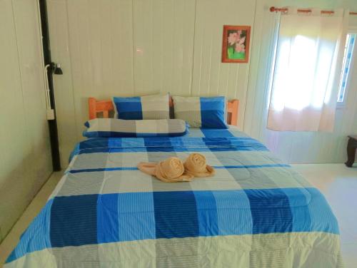 a blue and white bed with two hats on it at Lung peiyk homestay in Ban Bang Bao