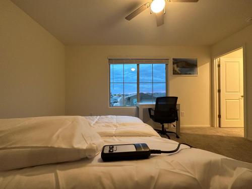 a bedroom with a bed with a phone on it at Breeze Valley Homestay in Tucson