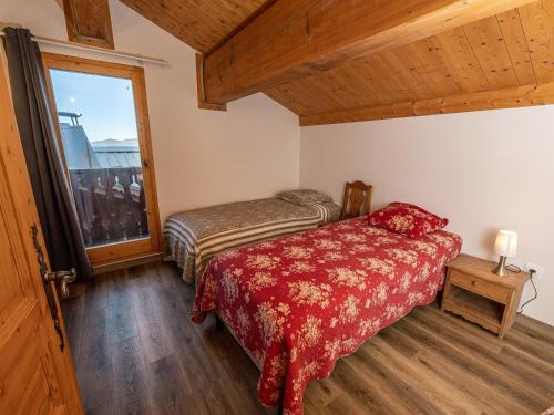 a bedroom with two beds and a large window at Chalet Plagne Soleil, 4 pièces, 8 personnes - FR-1-351-83 in Plagne Villages