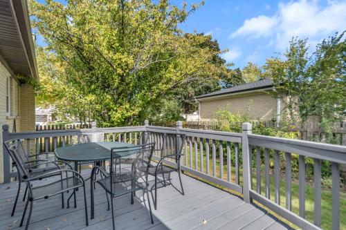 a patio with chairs and a table on a deck at Prime Location, Cozy & Spacious home in Schaumburg in Schaumburg