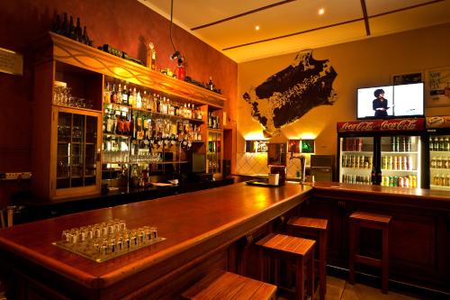 a bar with a large wooden counter in a room at Bahnhof Hotel Aus in Aus
