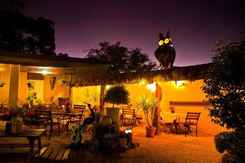 an owl sitting on top of a pergola at night at Bahnhof Hotel Aus in Aus
