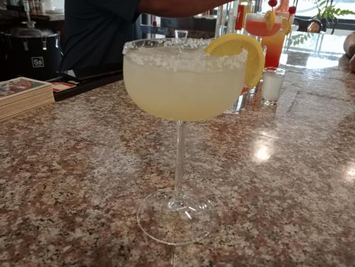 a drink in a glass with a lemon on a counter at Villa Italia Hotel in Sorsogon