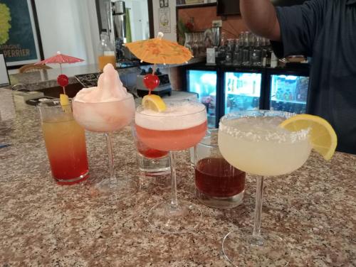 a group of four cocktails sitting on a counter at Villa Italia Hotel in Sorsogon