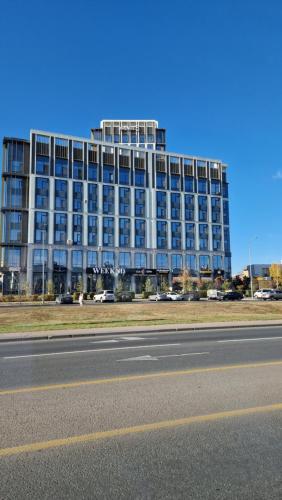 a large building on the side of a road at Стильная квартира в ЖК бизнес класса AVENUE 5 in Astana