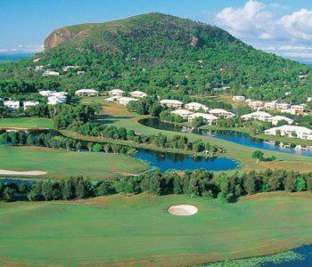 an aerial view of a golf course with a lake at Papillon Coolum in Coolum Beach