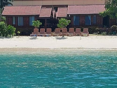 a group of chairs on a beach near the water at Phi Phi Sand Sea View Resort in Phi Phi Don