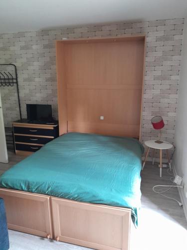 a bedroom with a large bed and a desk at Challes les eaux in Challes-les-Eaux