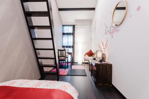 a bedroom with a spiral staircase and a living room at NEW-130m2 with 5toilets & 4 showers-Namba and USJ nearby in Osaka