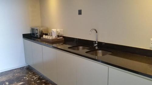 a kitchen with a sink and a counter top at Lagoon Beach Hotel & Spa in Cape Town