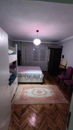 a bedroom with a bed and a room with a rug at Appartement au sous sol No 1 in Istanbul