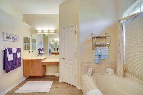 a bathroom with a tub and a sink at Ranch-Style Florida Retreat with Pool and Lanai in Merritt Island