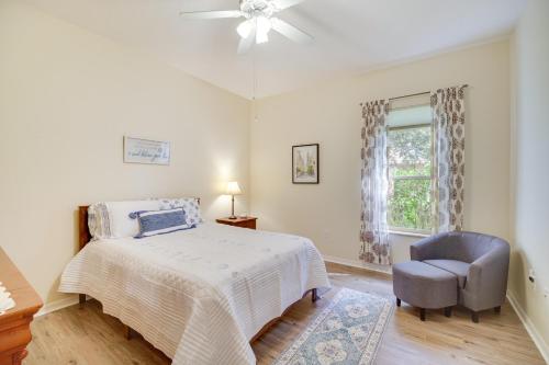 1 dormitorio con 1 cama, 1 silla y 1 ventana en Ranch-Style Florida Retreat with Pool and Lanai en Merritt Island