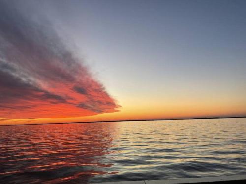 a sunset over a large body of water at Seaside Cottage: A 'MyShoreCottage' Property in Seaside Heights