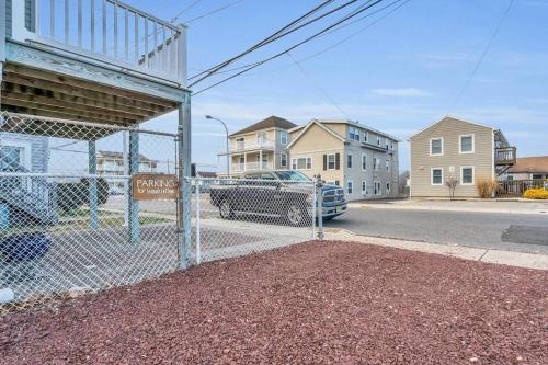 a fence in front of a street with houses at Seaside Cottage: A 'MyShoreCottage' Property in Seaside Heights