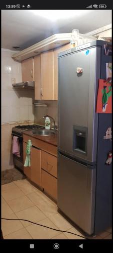 a kitchen with a stainless steel refrigerator and a stove at Sweet Home Center City in Chişinău
