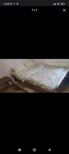 two beds sitting in a room with at Sweet Home Center City in Chişinău