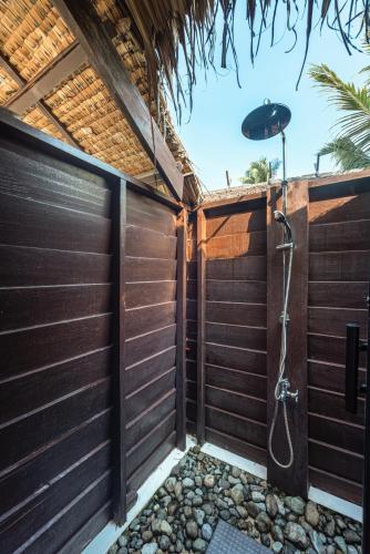 a bathroom with a shower in a fence at Siargao Island Villas in General Luna